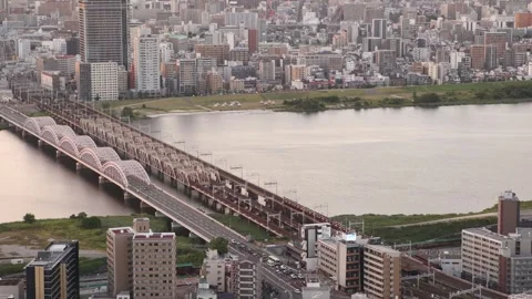 Panoramic aerial view across Osaka at sunset from the Umeda area, with dense Stock Footage 346330256
