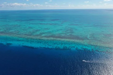 Panoramic aerial view of caribbean ocean with catamaran on deep blue sea Stock Photos