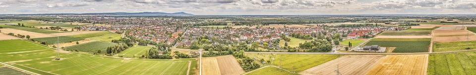 Panoramic aerial view of a cityscape with patchwork of vibrant green fields.. Fotos de archivo