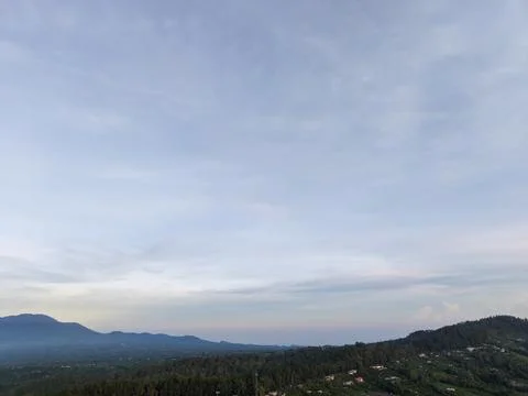 Panoramic Aerial View of Forested Mountain Hills under Soft Morning Sky Stock Photos