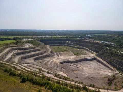 Panoramic aerial view of large open pit stone quarry and mining facility Fotos Stock