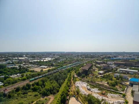 Panoramic aerial view of long freight cargo train traveling through industr.. Fotos Stock