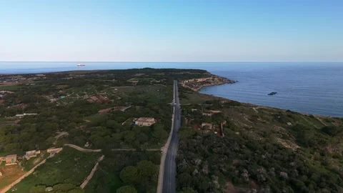 Panoramic aerial view of Mellieħa’s cliffs, blue sea, greenery and rural Stock-Footage 333424925