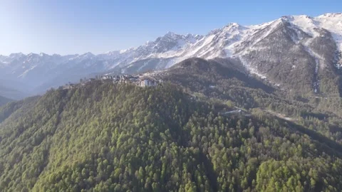 Panoramic aerial view of a mountain hotel resort surrounded by forest Stock Footage 337544965
