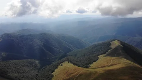 Panoramic Aerial View Of Mountain Ridges Covered With Forest And Sunlit Stock Footage 195929105