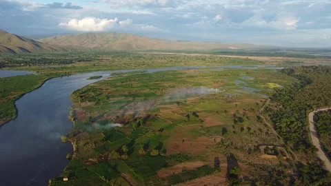 Panoramic aerial view of the nile river winding through a green landscape with Stock Footage 316950583