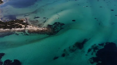 Panoramic aerial view over lagoon with turquoise water slowly descending Stock Footage