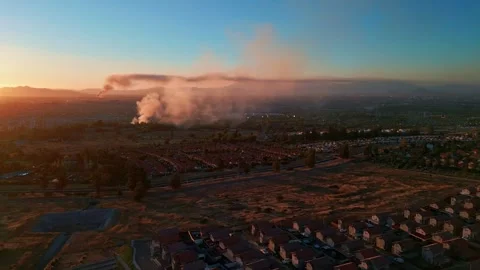Panoramic aerial view over vast residential suburb at sunset with dramatic Stock Footage 336267436