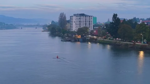 Panoramic aerial view of a person rowing on the Calle Calle River in Valdivia Stock Footage 338365025