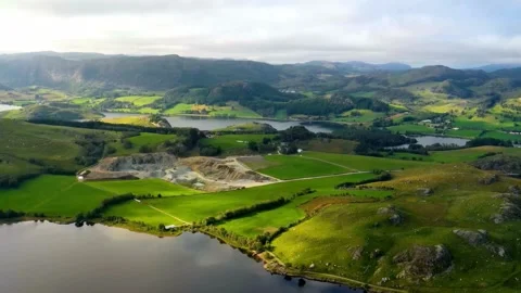Panoramic Aerial View of Rolling Green Hills and Serpentine Lake Video stock 308341453