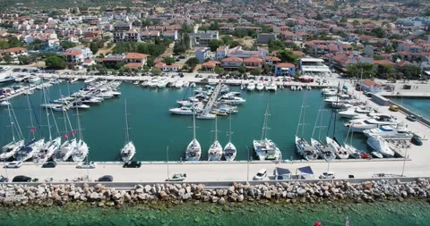 Panoramic aerial view showcasing a vibrant marina with moored yachts, surroun Video stock 304669107