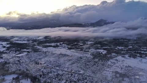 Panoramic aerial view of snow-covered Melipeuco, Chile, with clouds at sunset Stock Footage 345360659