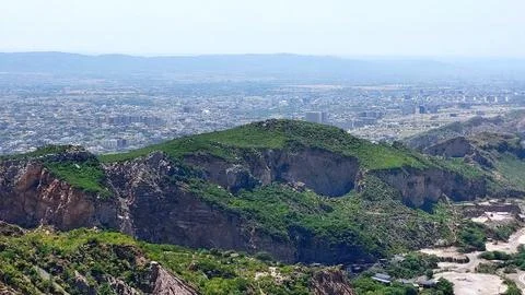 Panoramic Aerial View Of Urban Development Nestled Between Mountains Stock-Fotos