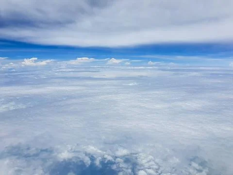 Panoramic aerial view of a vast cloud layer stretching to the horizon beneath dr Фото