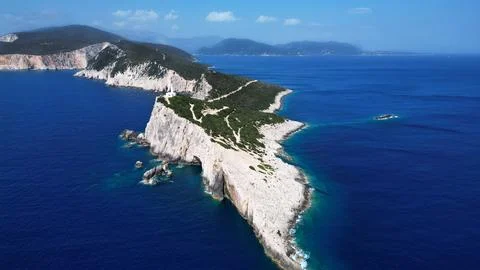 Panoramic Aerial View of White Lighthouse on Rocky Ocean Cape Photos