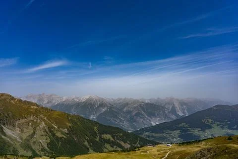 Panoramic Alpine Mountain Landscape With Valley, Rolling Hills, Distant Pea.. Stock Photos