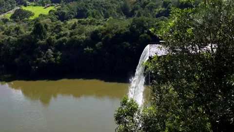 Panoramic and slow motion view of the lagoon and artificial waterfall Stock Footage 276573632