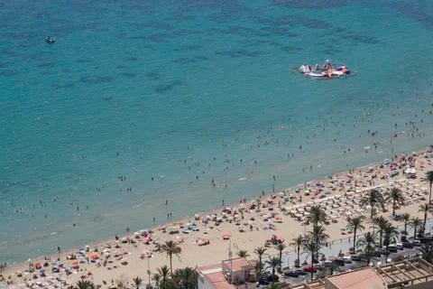 Panoramic of a beach with people bathing Stock Photos
