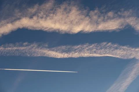 Panoramic of a beautiful blue sky with clouds and white trails. Nature. Stock Photos