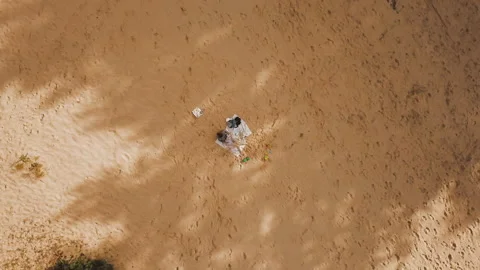 Panoramic birds eye view with rotating camera of a mother and son sitting in Video stock 136735645