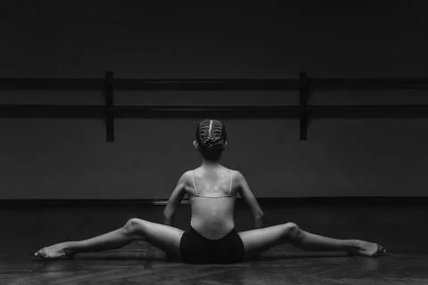 Panoramic black and white view of a beautiful young ballerina doing the split Stock Photos