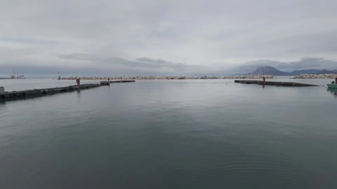 Panoramic calm sea view in harbor with mountains and grey sky Stock Footage 338106038