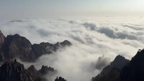 Panoramic Camera Movement Majestic Mountain Peaks Emerging from a Sea of Clo Video stock 328289516