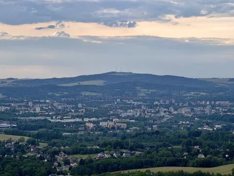 Panoramic city view beneath cloudy evening sky Stock Photos