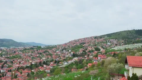 Panoramic cityscape with red tile roofs and hills on background. Stock Footage 245467344