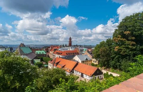 Panoramic cityscape view with the clock tower of City Hall and roofs of Hel.. Stock Photos
