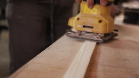 Panoramic close shooting of manual grinding process in carpenter's hand. Stock Footage 110356062