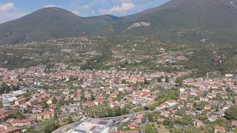 Panoramic Coastal Town at Foot of Mountains, Wide View, Elevated Drone Shot Stock Footage 343677055