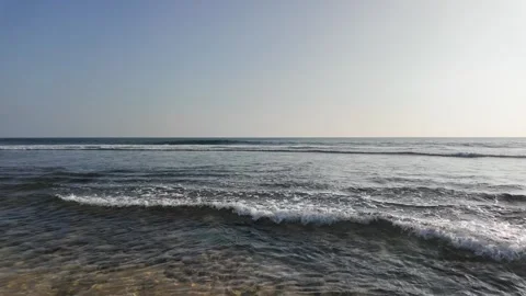 Panoramic Dawn, Rippling Ocean Waves &amp; Distant Rock Formation (Hazy Sky) Video stock 329033195