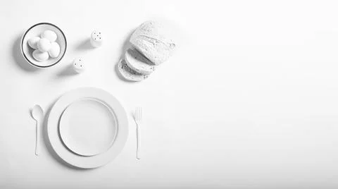 Panoramic design of white cutlery with bread, pepper dishes, salt shaker and  Stock Photos
