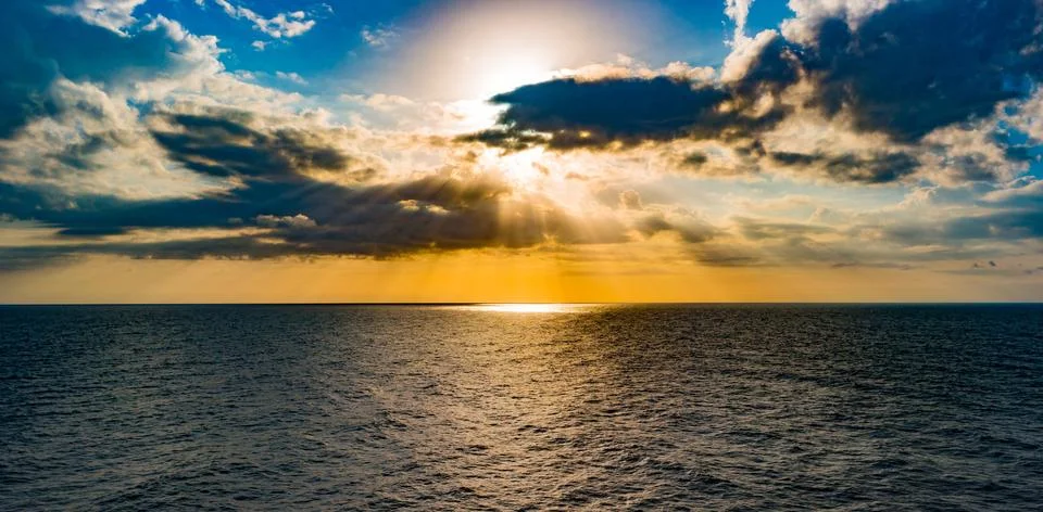 Panoramic dramatic sunset sky and tropical sea at dusk Stock Photos