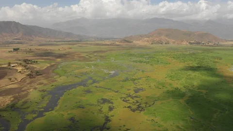Panoramic drone flight lush mountain valley, green pastures Ethiopia Africa Stockbeeldmateriaal 114338081