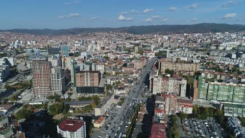 Panoramic drone flight over Bill Clinton boulevard, Pristina skyline Kosovo Stock-Footage 85937725