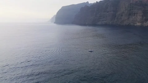 Panoramic Drone Orbit Around Yacht with Los Gigantes Cliffs, Tenerife, 4K Stock Footage 314735334