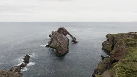 Panoramic drone shot of Bow Fiddle Rock rock formation in Scotland Stock Footage 334814882