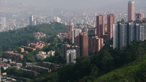 Panoramic drone shot circling tall condos in Medellin, golden hour in Colombia Stock Footage 308903579
