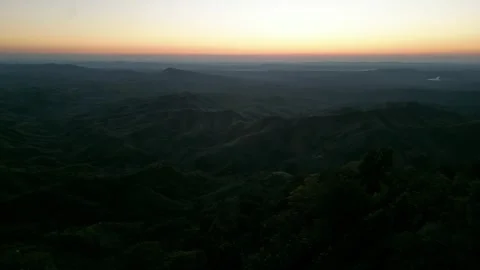 Panoramic drone shot of layered dark mountain valleys and vibrant twilight .. Vídeo Stock 345088825