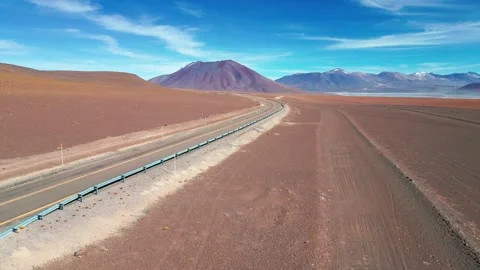 Panoramic drone shot over a desert highway cutting through a vast arid plain Stock Footage 333477164