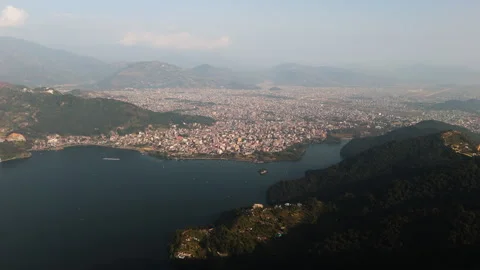Panoramic drone shot of the Pokhara valley and Phewa Lake, hazy sunset Stock Footage 341458546