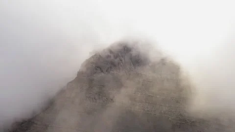 Panoramic drone shot of the Throne of Zeus emerging through dense clouds on Stock-Footage 330921785
