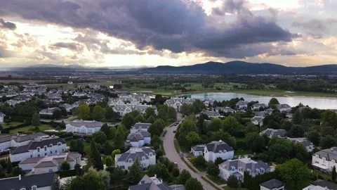 Panoramic drone view of American style suburban neighborhood, sunset time Stock Footage 234644988