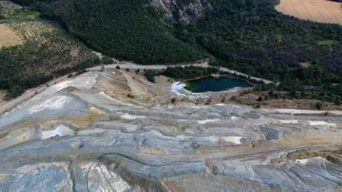 Panoramic drone view of the circular Tsar Asen mine pit in Bulgaria . Stock Footage 311750412