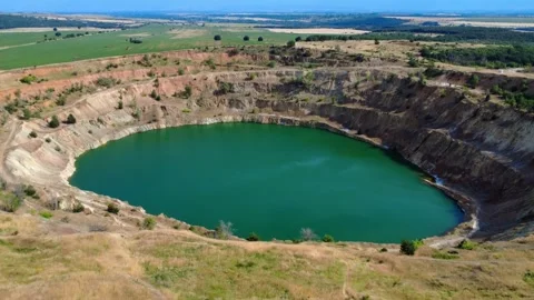 Panoramic drone view of the circular Tsar Asen mine pit in Bulgaria . Stock Footage 311750442
