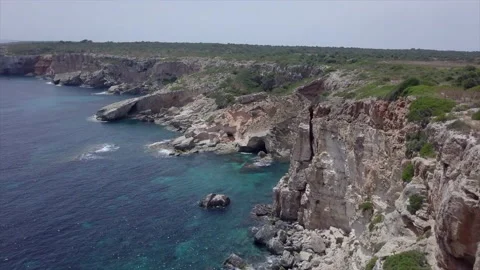 Panoramic drone view of a cliff by the crystal clear sea in Mallorca, Stock Footage 221739034
