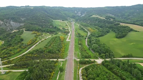 Panoramic drone view of a high-speed passenger train leaving the tunnel Stock Footage 243838899