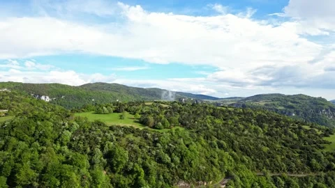 Panoramic drone view of tree-covered hillsides of the heights of the Vercors Stock Footage 242723862